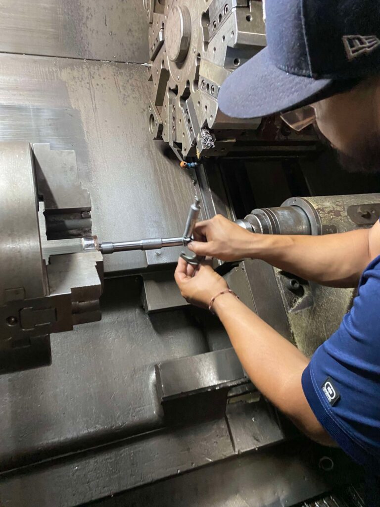 A person working on a machine in a factory.